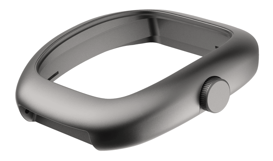 Isolated view of a hollow watch case middle in dark sandblasted titanium, shown at a three-quarter angle against a white background. The cushion-shaped case has no dial or movement installed, revealing its open interior. A knurled crown is fitted to the right side. The case shows integrated lug geometry with smooth, rounded transitions from the bezel edge down through the lugs, with a small pusher port visible on the left side. The matte finish and monolithic form emphasise the case's sculptural quality as a standalone component.